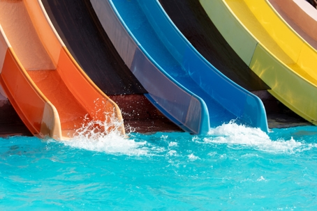 Red and blue slide in the pool of the water park stock photo