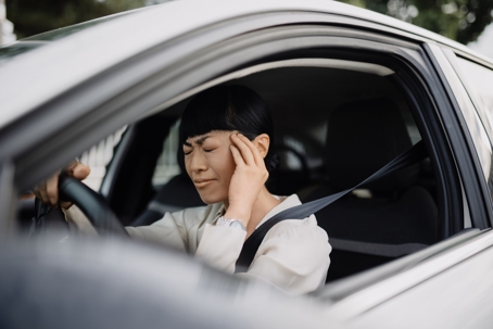 Frustrated Japanese woman sitting in her car during a traffic jam. stock photo
