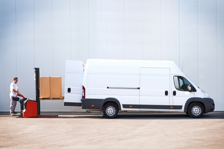 Courier is loading the van with parcels