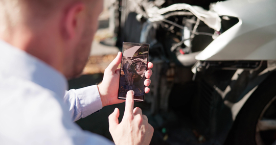 Insurance Investigator Captures Damaged Car After Accident stock photo