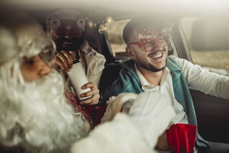 Men in a car dressed for a holiday party