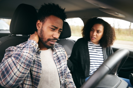 man holding his neck after an auto accident