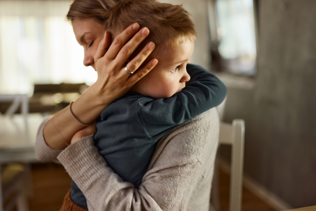 child and mother embracing in a hug