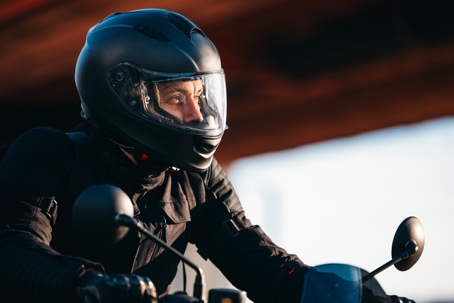 Portrait of an Anonymous Motorcycle Rider Driving on a Sunny Day